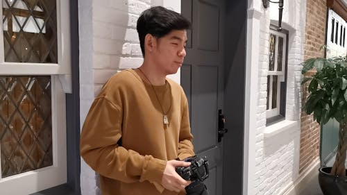 Guy Doing a Test Shot on His DSLR Camera