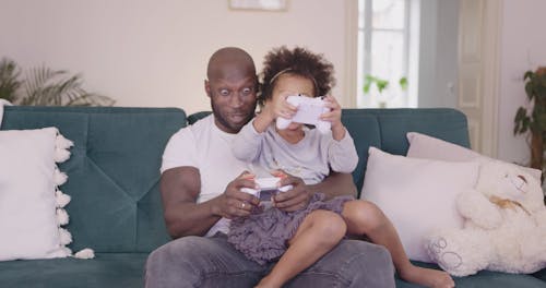 Dad Playing Video Games With Her Daughter
