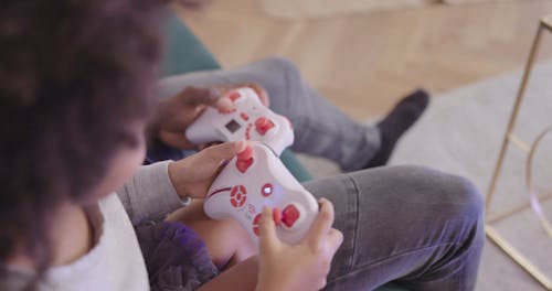 Dad Playing Video Game With Her Daughter