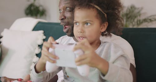 A Father And Daughter Bonding Over A Computer Game
