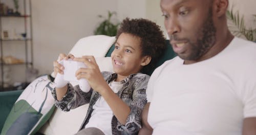 Dad And Son Playing A Computer Game