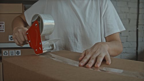 Sealing Cardboard Box with Adhesive Tape