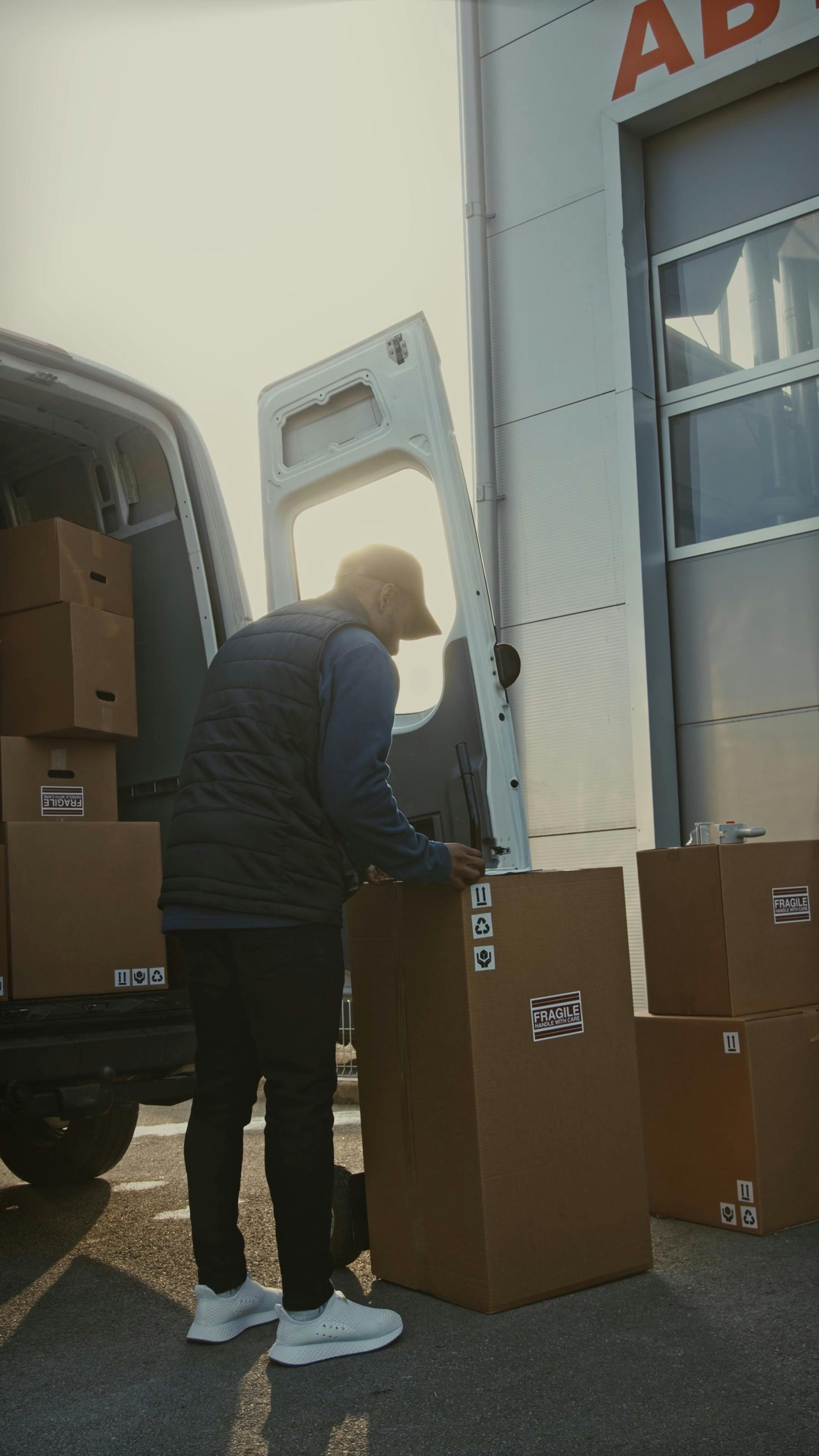 Man Unloading Delivery Cartons from a Van · Free Stock Video