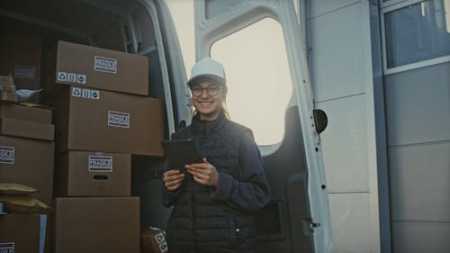 Female Worker Next to Delivery Truck