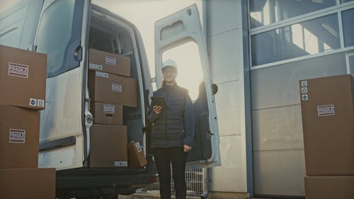 Female Worker Next to Delivery Truck