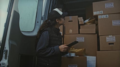 Female Worker Checking a Delivery Truck