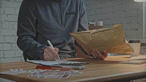 Workers Checking Delivery Boxes