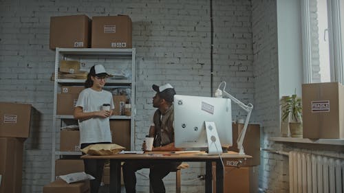 Workers Next to Delivery Boxes