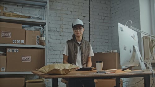 Female Worker Next to Delivery Boxes