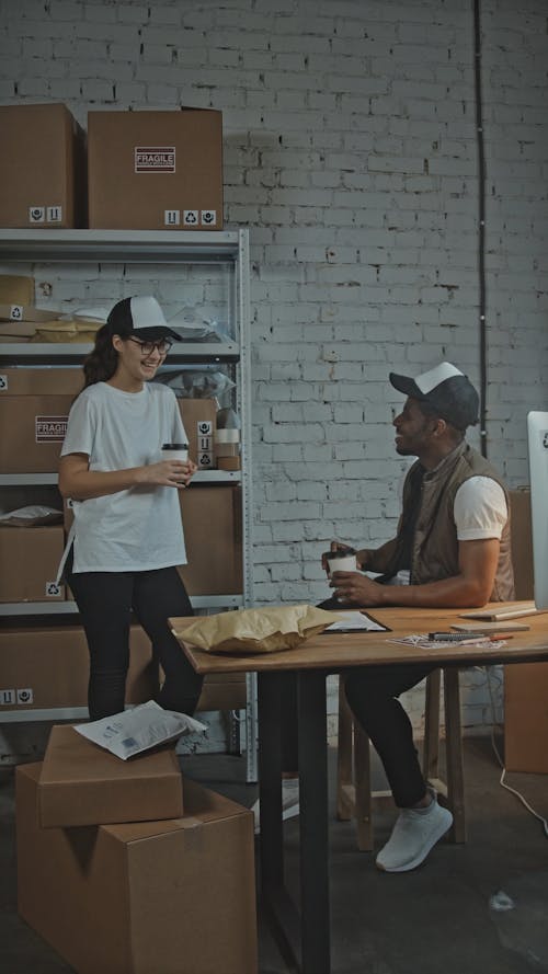 Two People Next to Cardboard Boxes