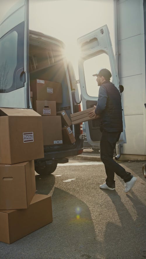 Man Loading Parcels in Van to Deliver