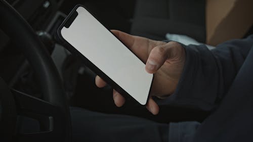 Delivery Man Working Over his Mobile Phone 