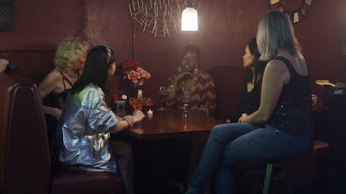 Group of Female Friends Talking and Drinking at the Bar
