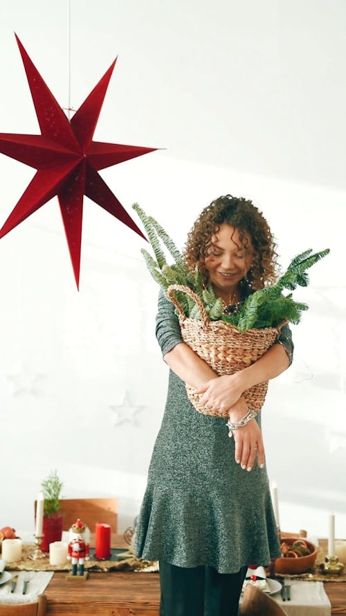 Woman Holding basket of Christmas Décor