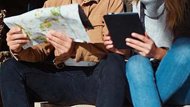 a couple having conversation while looking at the map
