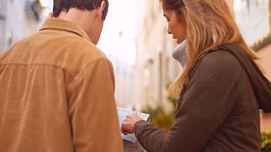 couple looking at a map and pointing to a direction