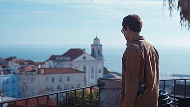 young man enjoying coastal town viewpoint