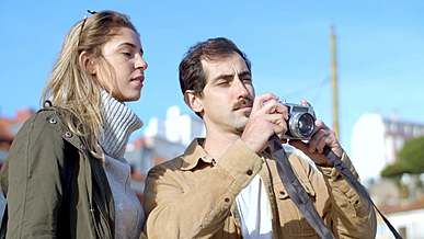 a couple taking pictures outside