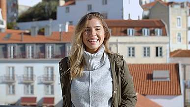 smiling woman posing and looking at camera