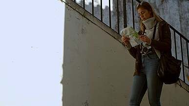 woman with map in hand looking for location