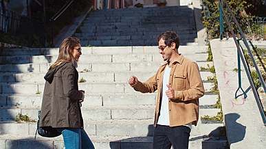 young couple dancing by the stairs