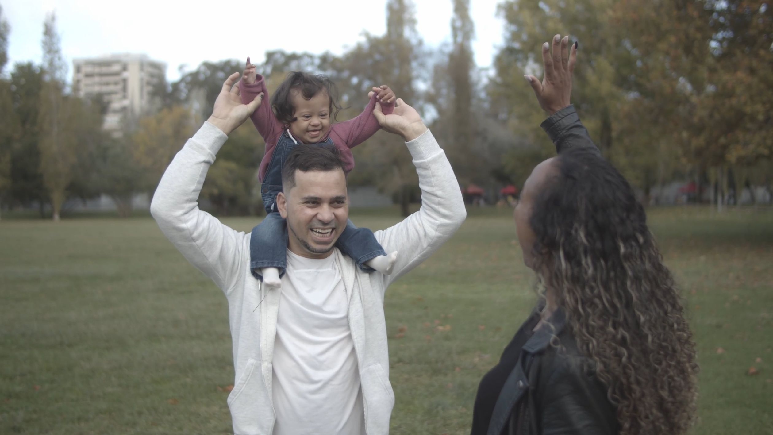 Man Carrying a Baby on His Shoulder and Woman Having a Bonding Time at ...