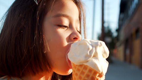 Little Girl Having Ice Cream Outdoors