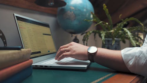 A Person Typing on a Laptop