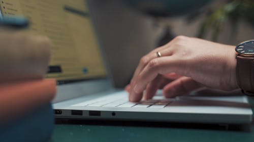 Close-Up of a Person Typing on Laptop