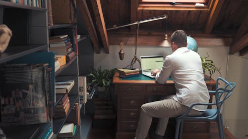 Back View of a Man Typing then Answering a Call