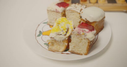 Various Types of Bread on a Ceramic Plate Beside a Chessboard