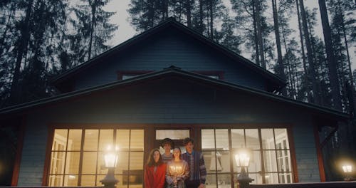 People Standing in Front of a Country House