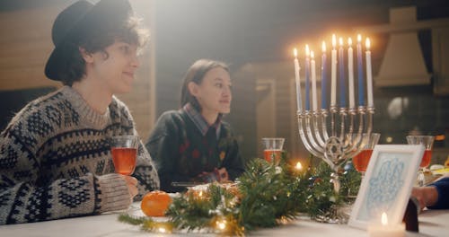 Friends Standing In The Dinning Table for Hanukkah Celebration