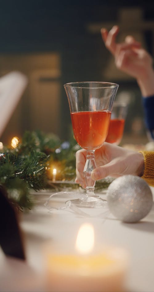 A Person Holding a Glass with a Cocktail Drink