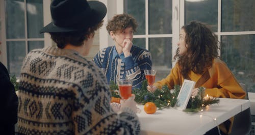 Young Friends Toasting In The Dining Table