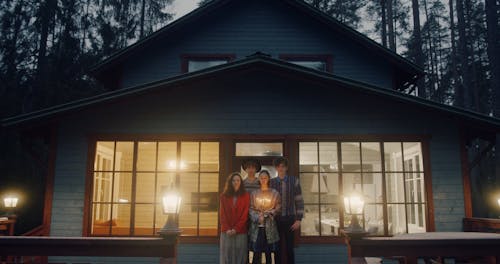 Jewish Friends Posing With Hanukkah Menorah In A Cabin House