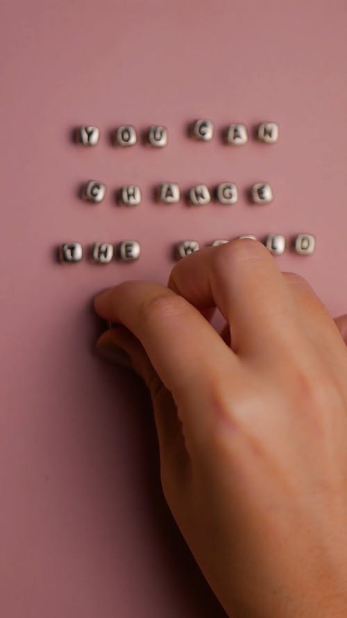 Person Laying Beads on a Flat Surface