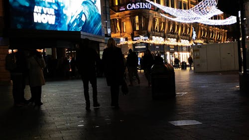 People Walking in the Street at Night