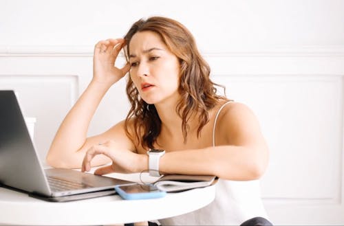 a Stressed Woman Using Laptop