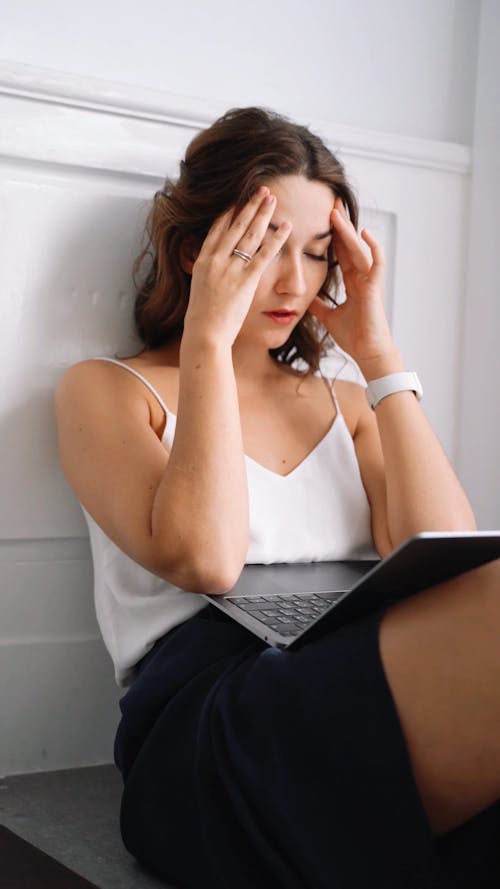 a Stressed Woman Using Laptop