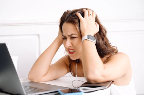 Stressed Woman Using Laptop Showing Frustration