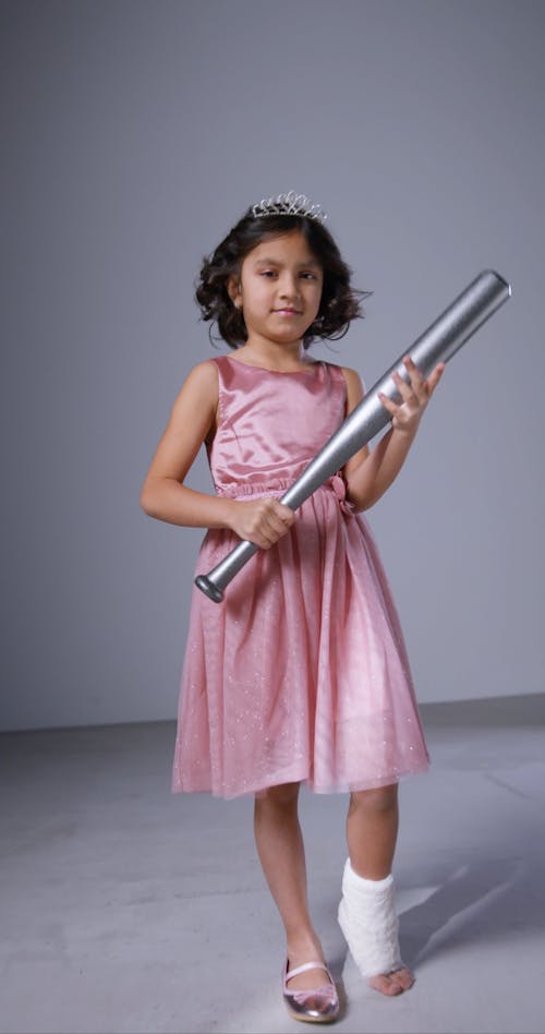 Girl With Broken Ankle Holding a Baseball Bat