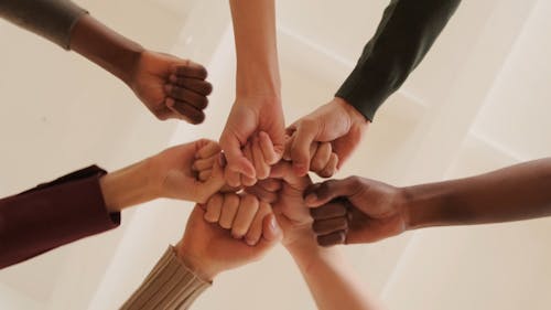 Crop Group Stacking Hands Together