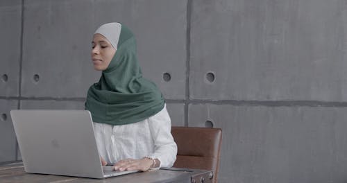 Woman in Hijab Using Laptop