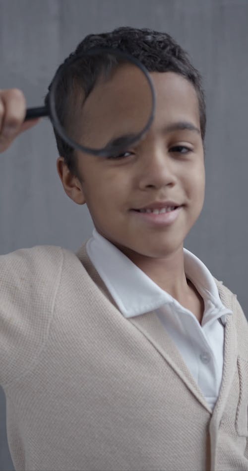 Little Boy Playing with Magnifying Glass