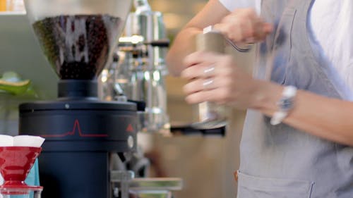 Man Using a Coffee Bean Grinder