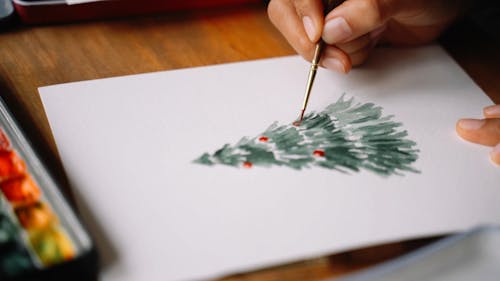Person Painting Christmas Tree