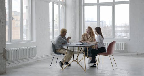 Young People Sitting at Table and Talking