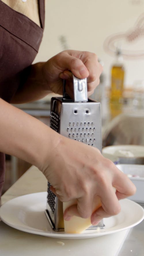 Person Grating Cheese