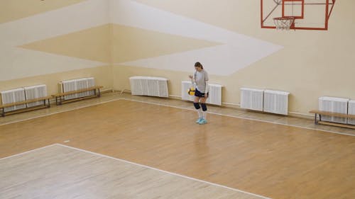 Woman Serving Volleyball Ball
